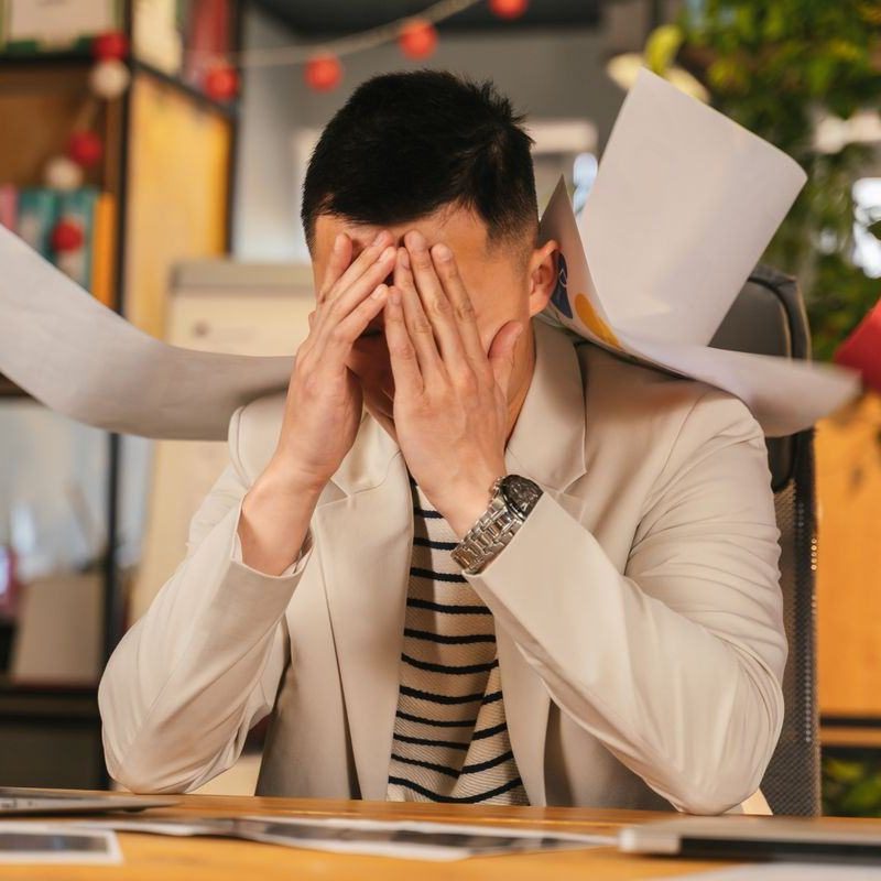 Stressed candidate with his head in his hands